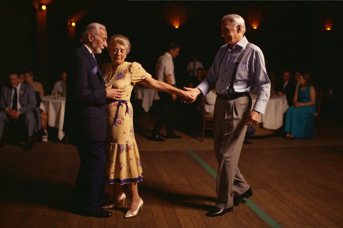 Grandparents dancing together late in the night.